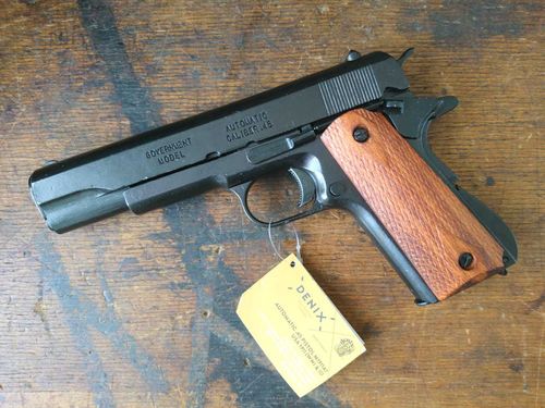 US Colt 1911 with ribbed wooden grips, pistol replica made of cast metal. Defective